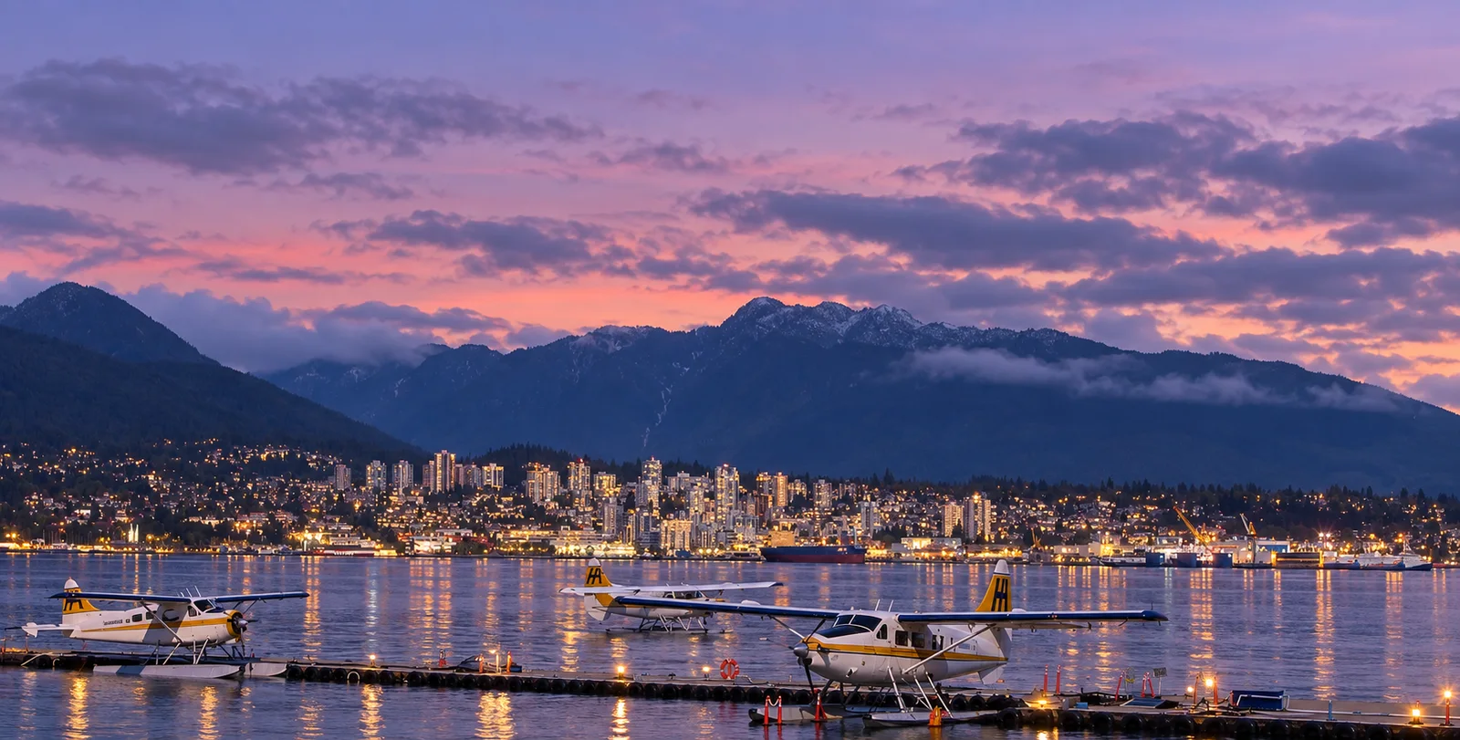 North Vancouver waterfront with floatplanes on Burrard Inlet and the North Shore mountains behind the city