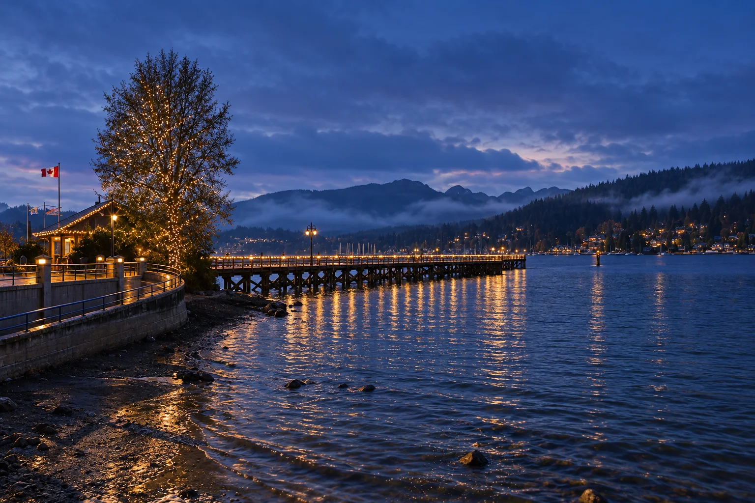 The wooden pier at Rocky Point Park extending into Burrard Inlet with forested slopes beyond, Port Moody