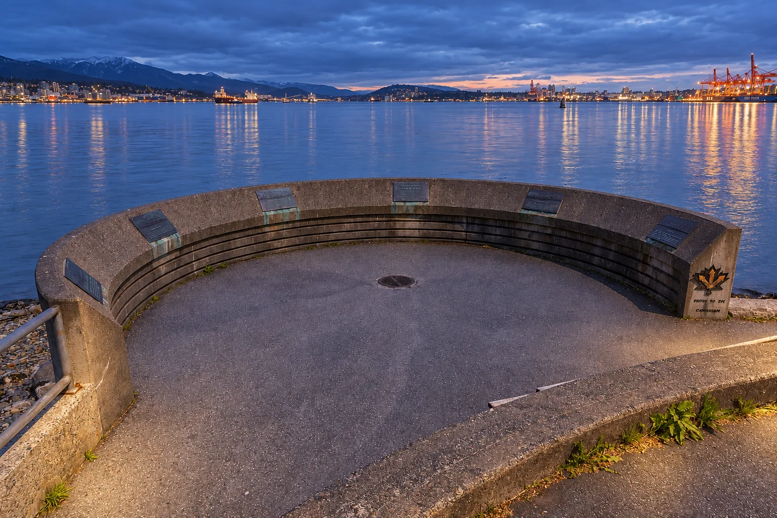 The Port of Vancouver Lookout seawall viewpoint with Burrard Inlet, mountains, and harbour cranes in Stanley Park